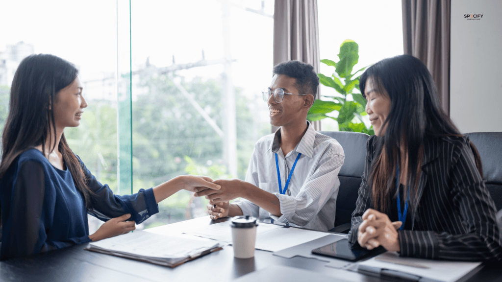 Furniture industry hiring manager discussing a job offer with a candidate, representing the importance of communication and speed in preventing offer rejections in commercial furniture recruitment.